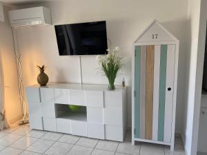 a white cabinet with a tv on top of it at Perla Di Mar in Cavalaire-sur-Mer +9 photos