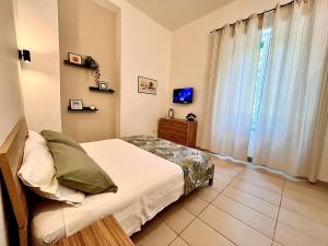 a bedroom with a bed and a large window at DMC Residence - Alloggi Turistici in Anzio