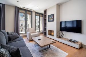 a living room with a couch and a tv at Sentire Hotels & Residences Taksim in Istanbul