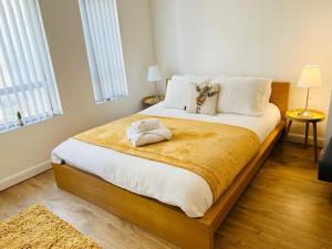 a bedroom with a bed with a stuffed animal on it at Luxury Studio Apartment in Luton