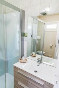 a bathroom with a sink and a mirror at le Relais des Tuileries in Séreilhac +32 photos