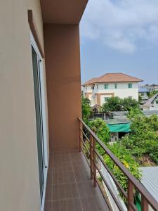 a balcony with a view of a building at เคทู เกสเฮาส์ (K2 Guesthouse) in Chon Buri