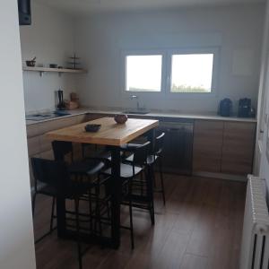 a kitchen with a wooden table and some chairs at Playa de Comillas in Comillas