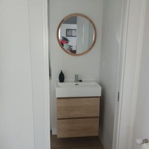 a bathroom with a sink and a mirror at Playa de Comillas in Comillas