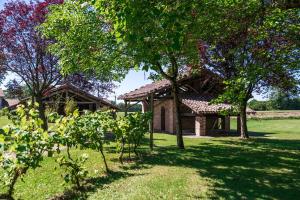 a house in a field with trees in front of it at le Relais des Tuileries in Séreilhac