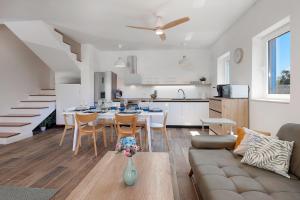 a living room and kitchen with a table and chairs at Papa's Court V Pasman Villa with pool in Pašman