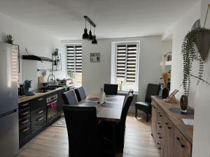 a kitchen and dining room with a table and chairs at L'APPARTEMENT BOULONNAIS in Boulogne-sur-Mer