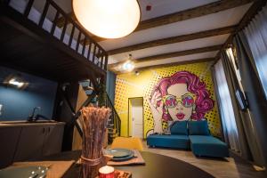 a dining room with a couch and a painting of a woman at Casa Verde - Brasov Homes in Braşov