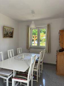 a dining room with a white table and chairs at Apartament u Zosi in Wisełka +5 photos