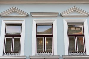 a white building with four windows on it at Vila Katharina in Braşov