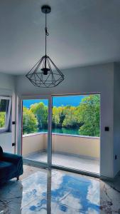 a living room with a large window with a view at Apartment Vila Tara in Bihać