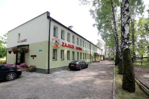 a building with a car parked in front of it at Zajazd Monki in Mońki