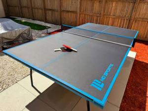 a ping pong table with a pair of scissors on it at Walk to Hard Rock ~ Amazing 5 Star Home Away From Home! in Miami Gardens