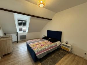 a bedroom with a blue bed and a window at L'APPARTEMENT BOULONNAIS in Boulogne-sur-Mer +11 photos