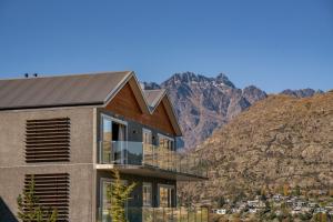 a house with a view of the mountains at Lakefront Penthouse Apartment with 270-degree view in Queenstown