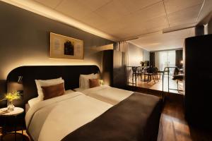 a bedroom with a large bed and a living room at Hotel Hasselbacken in Stockholm +37 photos