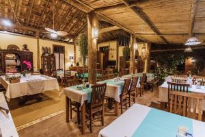a restaurant with tables and chairs in a room at Pousada Terra Madre in Ilhabela