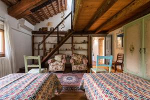 a bedroom with two beds and chairs and a staircase at Scuderia Country Mansion 3300SquareFeet in Vanzo +24 photos