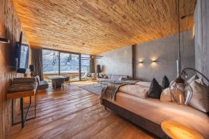 a bedroom with a large bed with a wooden ceiling at Mountain View in Kaltenbach