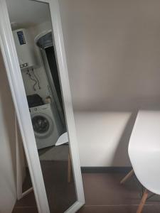 a mirror in a room with a washing machine at Lambertu ielas rezidence in Mārupe