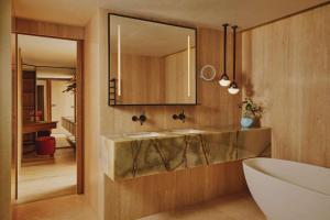 a bathroom with two sinks and a mirror at The Emory in London