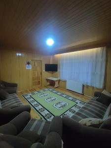 a living room with two couches and a rug at AYDIN HOME Uzungöl in Uzungöl