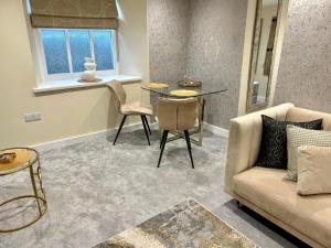 a living room with a couch and a table at Oasis Boutique New Luxury Apartment , 5 Minutes To Lake Windermere in Bowness-on-Windermere