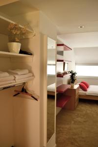 a bathroom with a mirror and a bedroom with a bed at Studio in Ljubljana Center in Ljubljana