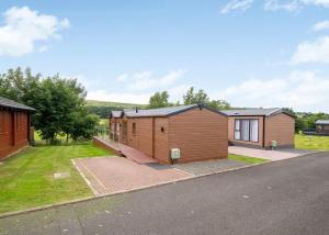 a row of modular homes on the side of a road at Riverview Holiday Park in Newcastleton