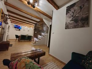 a living room with a couch and a table at Gímes Apartman in Cserszegtomaj