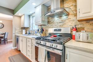 a kitchen with a stove and a sink at Serene Presque Isle Harbor Home on Sunrise Side! in Presque Isle