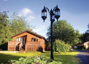 a house with a light pole in front of a house at Angecroft Park in Ettrick