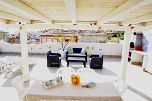 a patio with a table and chairs on a roof at LaCassiopea in Donnalucata