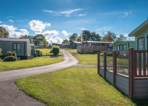 a winding road through a village with houses at Docker Holiday Park in Carnforth