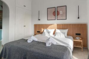a bedroom with a large bed with two pillows at Relaxing Sea View Studio at Xenios Avlais in Alikanas