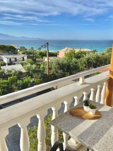 a table on a balcony with a view of the ocean at Relaxing Sea View Studio at Xenios Avlais in Alikanas