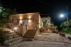 a stone house at night with stairs leading to it at Relaxing Sea View Studio at Xenios Avlais in Alikanas