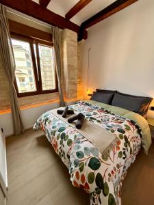 a bedroom with a bed with two shoes on it at Apartments & Boutique Meraki in Ontinyent