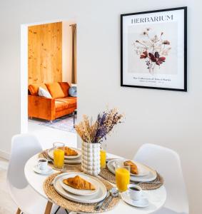 a white dining room table with breakfast foods on it at Apartment Quiet Street 11/1E in Oświęcim +7 photos