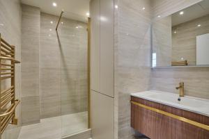 a bathroom with a sink and a shower at Eiffel Tower Apartment/Invalide by Studioprestige in Paris +10 photos