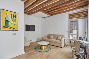 a living room with a couch and a table at Eiffel Tower Apartment/Invalide by Studioprestige in Paris