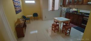 a kitchen with a small table and chairs in it at Óscar guest house in Mindelo