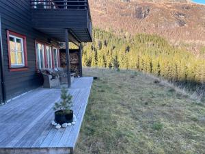 a porch of a house with a potted plant on it at Voss Resort Bavallstunet in Skulestadmo