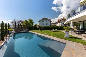 a swimming pool in the backyard of a house at Villa Aich in San Paolo