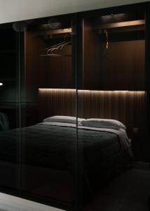 - une chambre avec un lit dans une armoire en verre dans l'établissement La Martina Home, à Valguarnera Caropepe