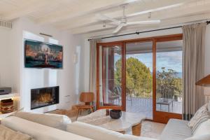 a living room with a couch and a fireplace at Apartamento de diseño MAREA ALTA - WeHost Costa Brava in Calella de Palafrugell