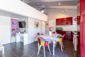 a kitchen and dining room with a table and chairs at Logis Du Conflent in Rodès