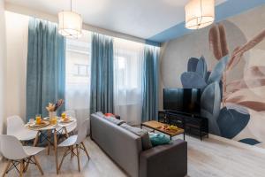 a living room with a couch and a tv at Apartment Quiet Street 11, 3E in Oświęcim