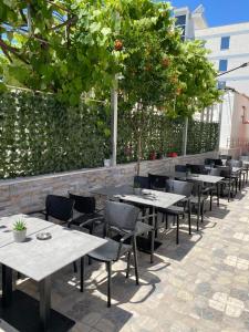 a row of tables and chairs on a patio at Villa Rafail in Ksamil