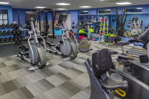 a gym with several treadmills and exercise bikes at Bournemouth West Cliff Hotel in Bournemouth
